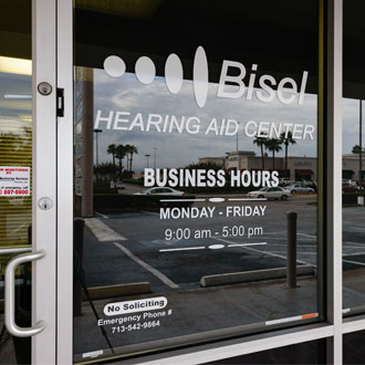 front door of Bisel Hearing Aid center with business hours