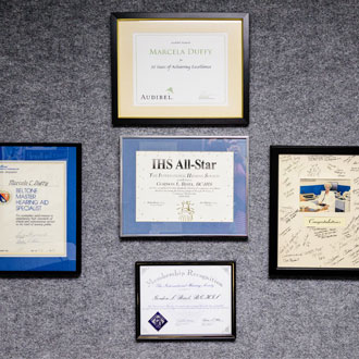 wall at Bisel Hearing Aid center with various framed awards