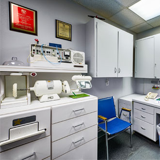 room at Bisel Hearing Aid Center with cabinets and audio equipment